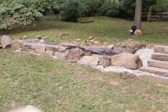 Boulder wall being built